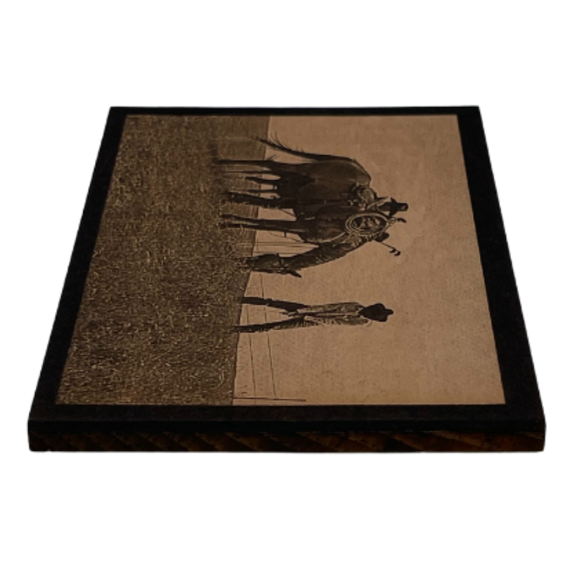 A Side Angle Of A Wood Printed Photograph Of Two Cowboys Playing Golf In A Field Alongside A Grazing Horse