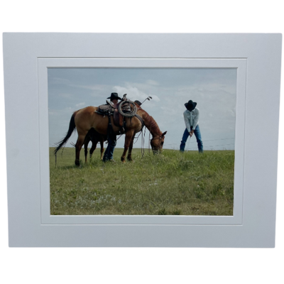  Photograph Of Two Cowboys Playing Golf In A Field Alongside A Grazing Horse 