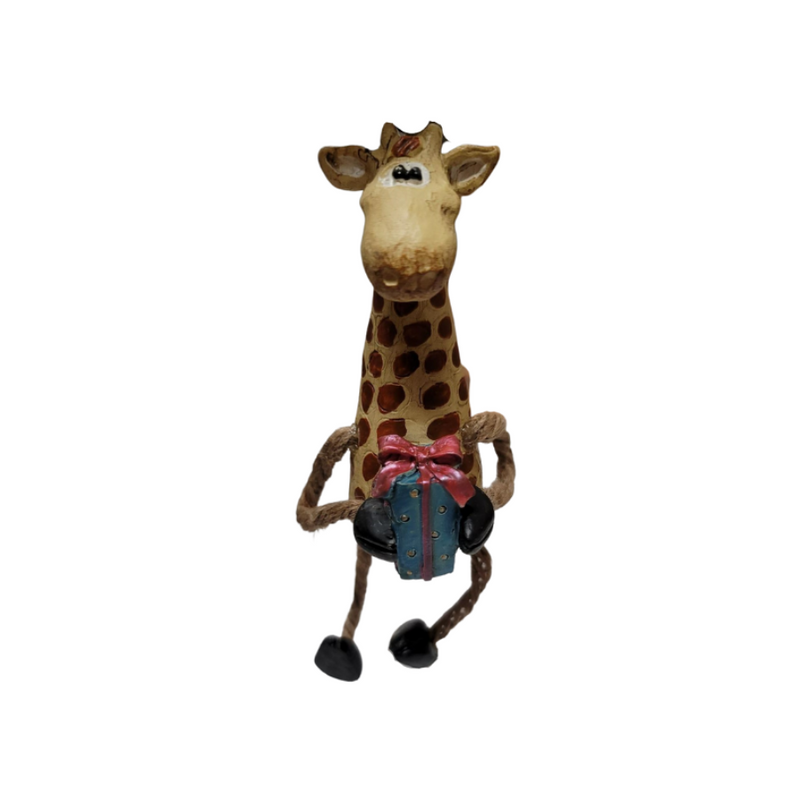 Giraffe ornament with jute-rope legs and holding a wrapped gift with front hoofs on a white background