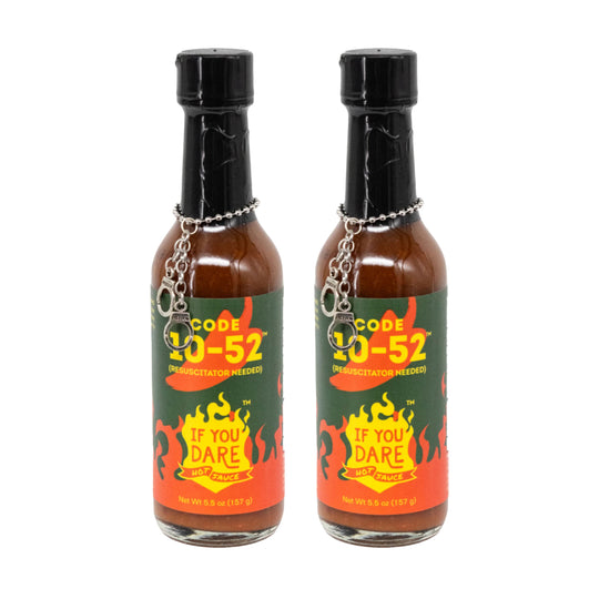 Two bottles of Code 10-52 hot sauce with black caps and colorful labels on a white background.