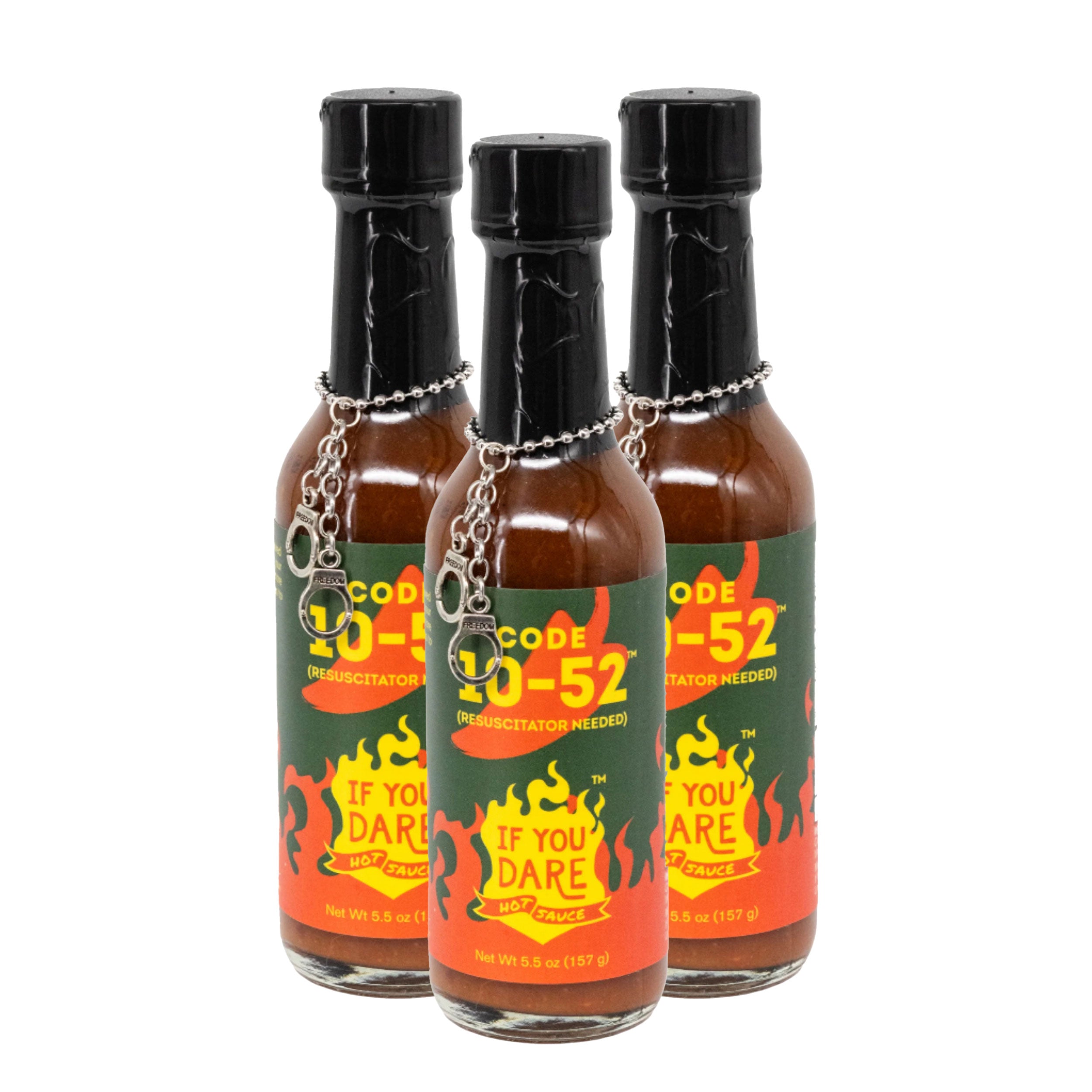 Three bottles of Code 20-52 hot sauce with black caps on a white background