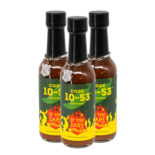 Three bottles of Code 10-53 hot sauce on a white background