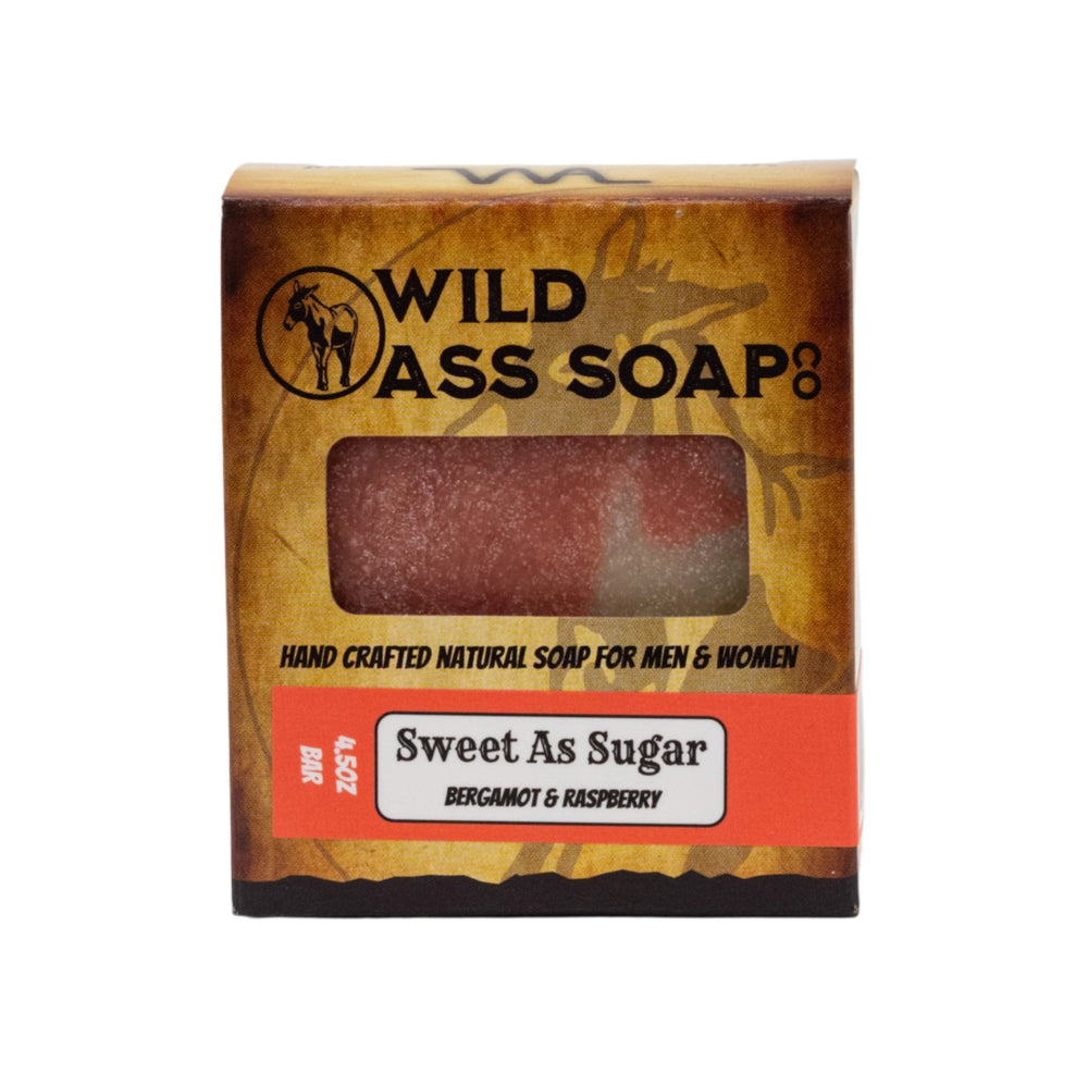 A packaged bar of soap labeled 'Wild Ass Soap Co. Sweet As Sugar' with a window showing the red bar of soap inside.