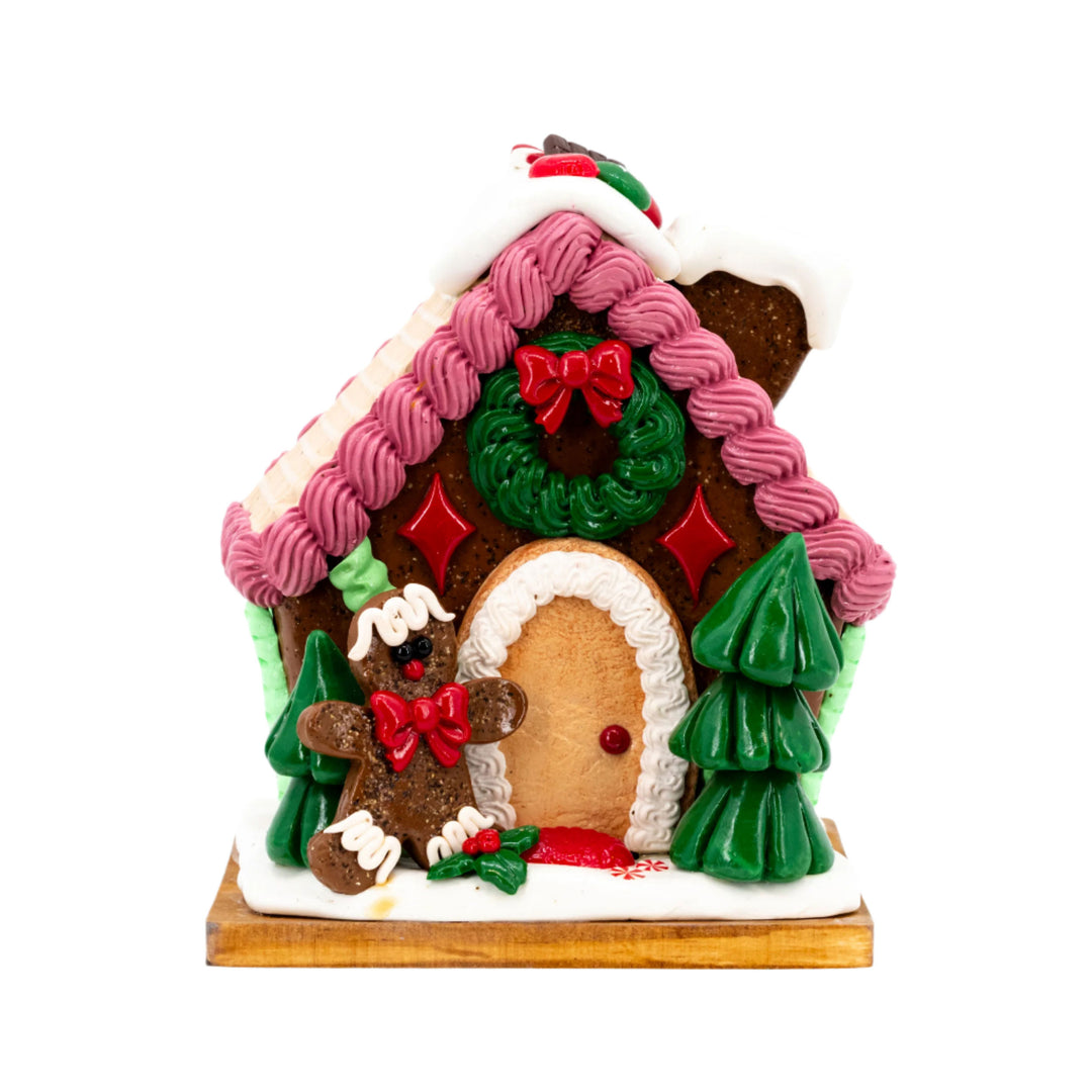 Decorative gingerbread house with candy decorations on a white background
