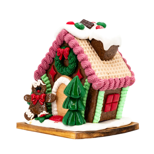 Decorative gingerbread house with colorful icing on a white background