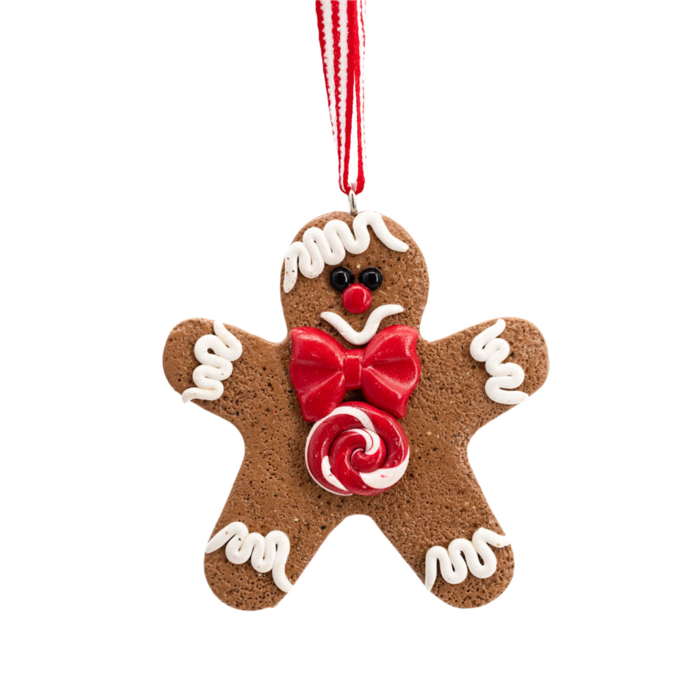 A handcrafted polymer clay gingerbread man ornament with a red bow tie designed for holiday decoration.