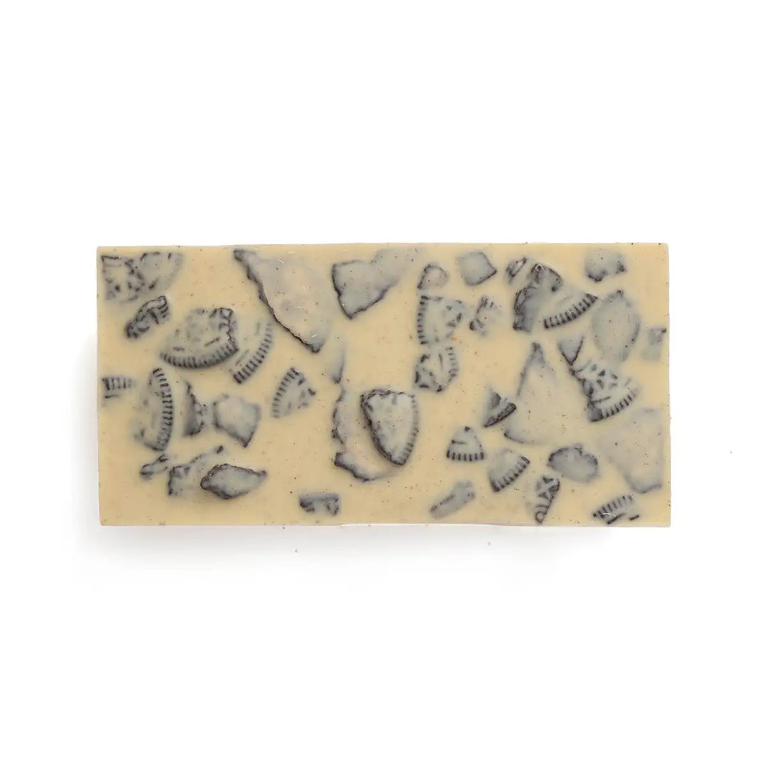 Block of cookies & cream chocolate with visible cookies on a white background