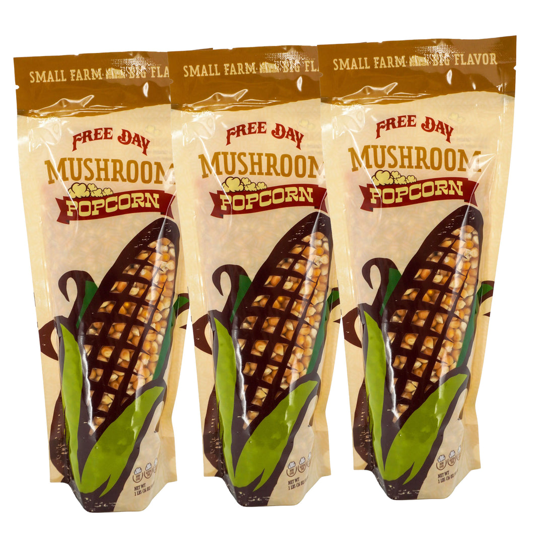 Three packages of Free Day Mushroom Popcorn on a white background