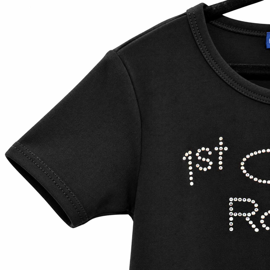 Close-up of a black short-sleeve t-shirt on a hanger, featuring white rhinestone lettering that reads '1st C.
