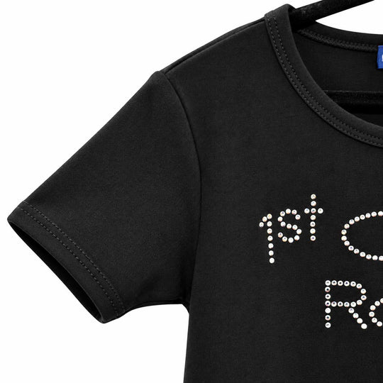 Close-up of a black short-sleeve t-shirt on a hanger, featuring white rhinestone lettering that reads '1st C.
