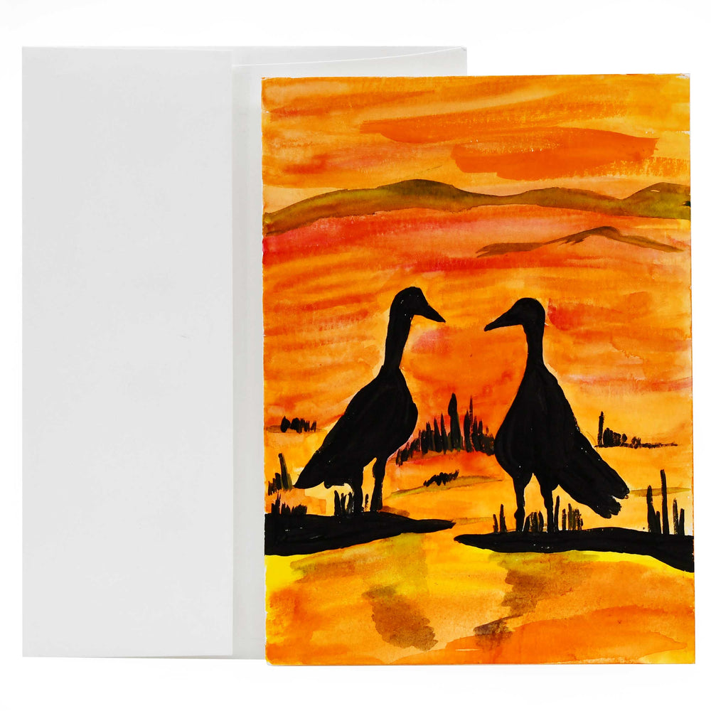 Greeting card with two ducks on a sunset landscape