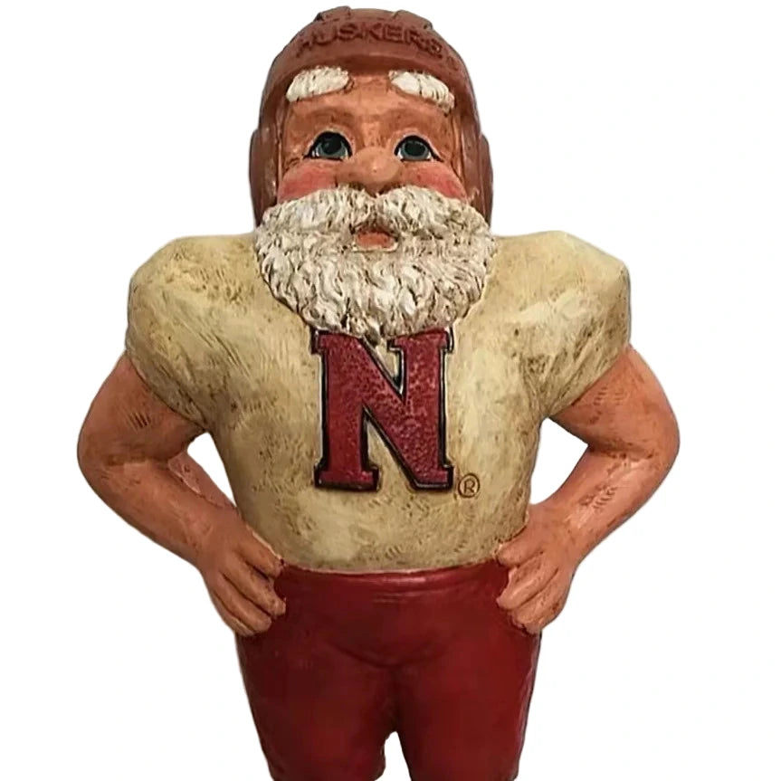 Vintage football player figurine with 'Nebraska' helmet and jersey on a white background