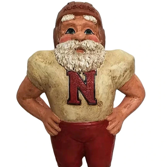 Vintage football player figurine with 'Nebraska' helmet and jersey on a white background