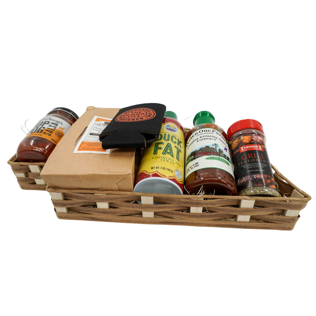 Basket with various bbq products in a gift basket on a white background