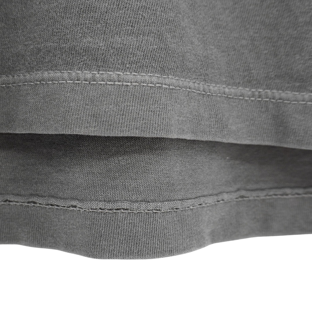 Close-up of a gray fabric with stitching details on a white background