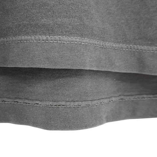 Close-up of a gray fabric with stitching details on a white background