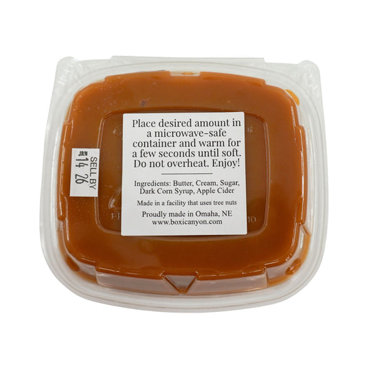 Container of caramel with a label on a white background