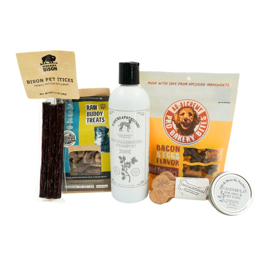 Collection of pet products including treats, a bottle, and a package on a white background