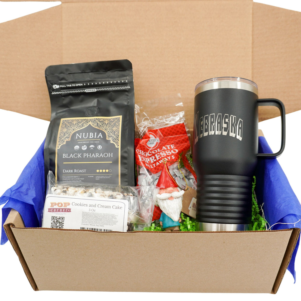 Box containing a Nubia coffee bag, a Nebraska mug, and other items on a white background