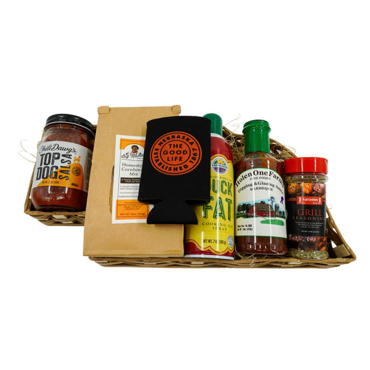 Basket of grilling products in a Nebraska shaped gift basket on a white background