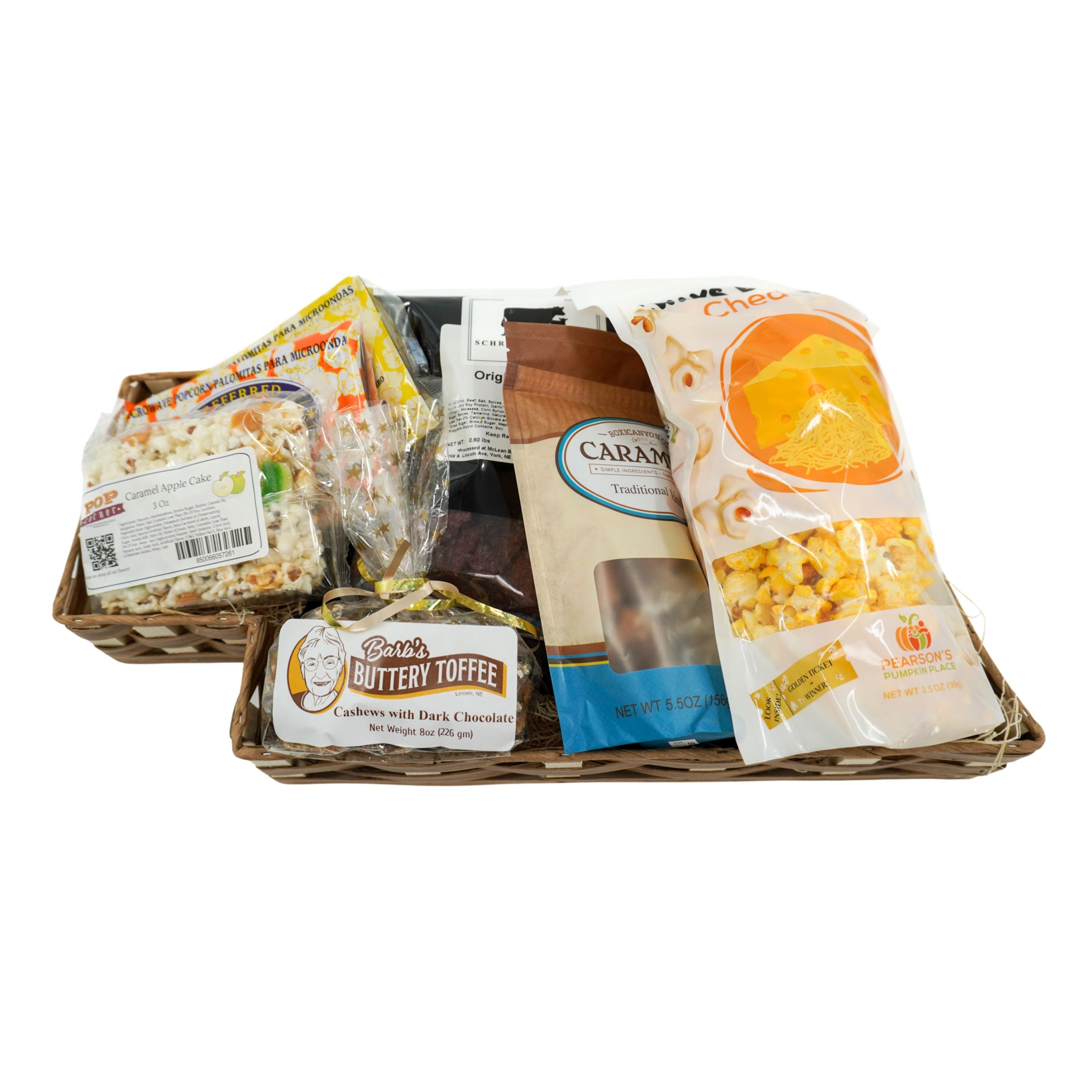 Assorted snack items including popcorn and candy in a Nebraska-shaped basket on a white background