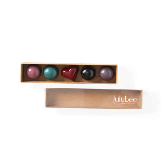 Set of colorful heart-shaped objects in a Lulubee box on a white background