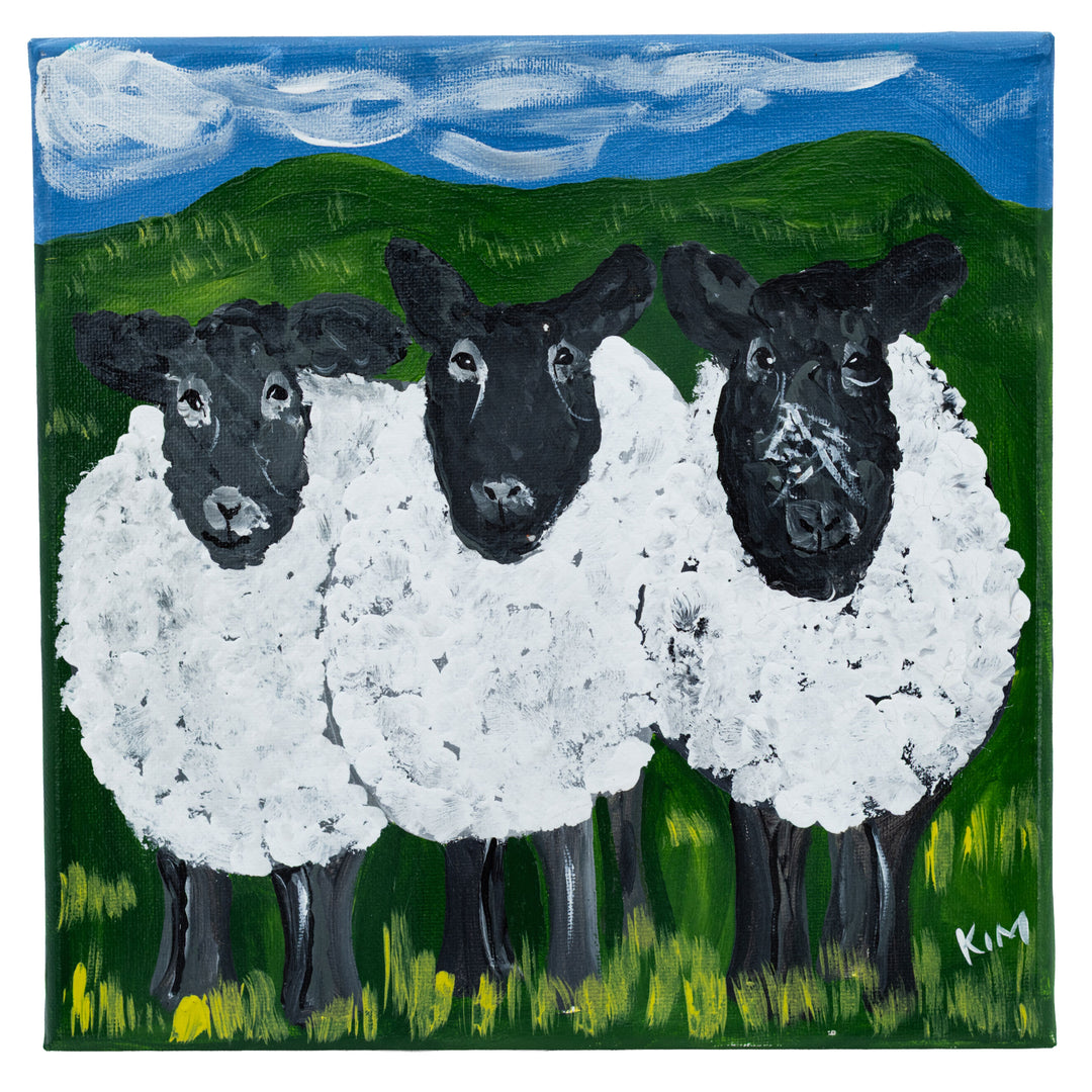 Painting of three sheep with black faces and white wool in a green field with blue sky.