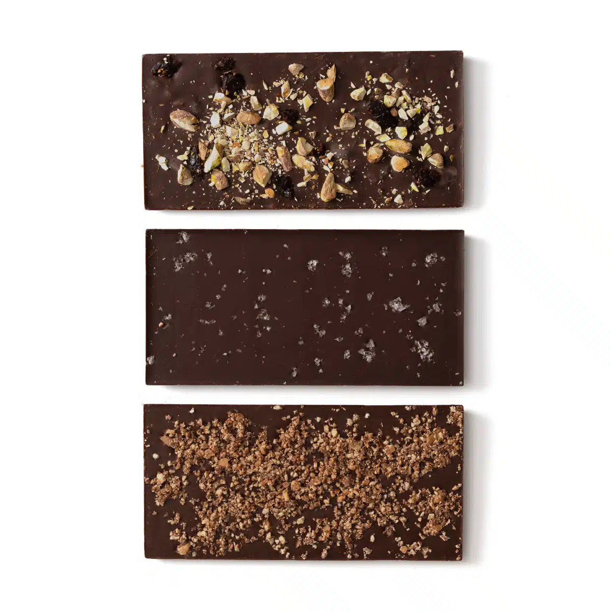 Three dark chocolate bars with various toppings on a white background