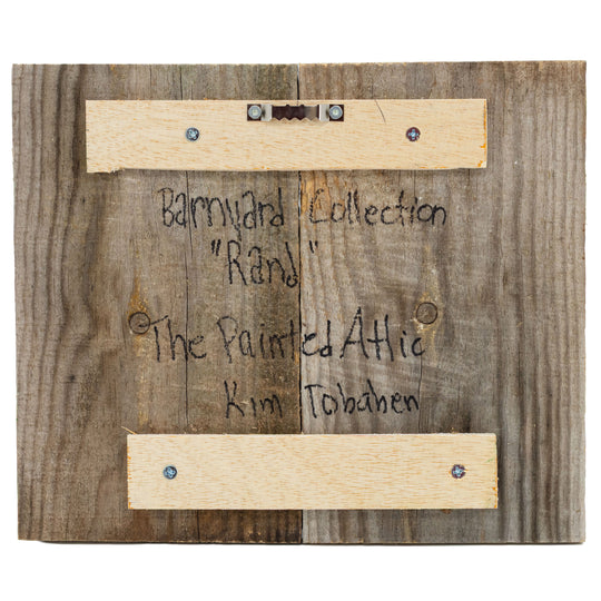 Wooden plaque with text and hardware on a wooden background