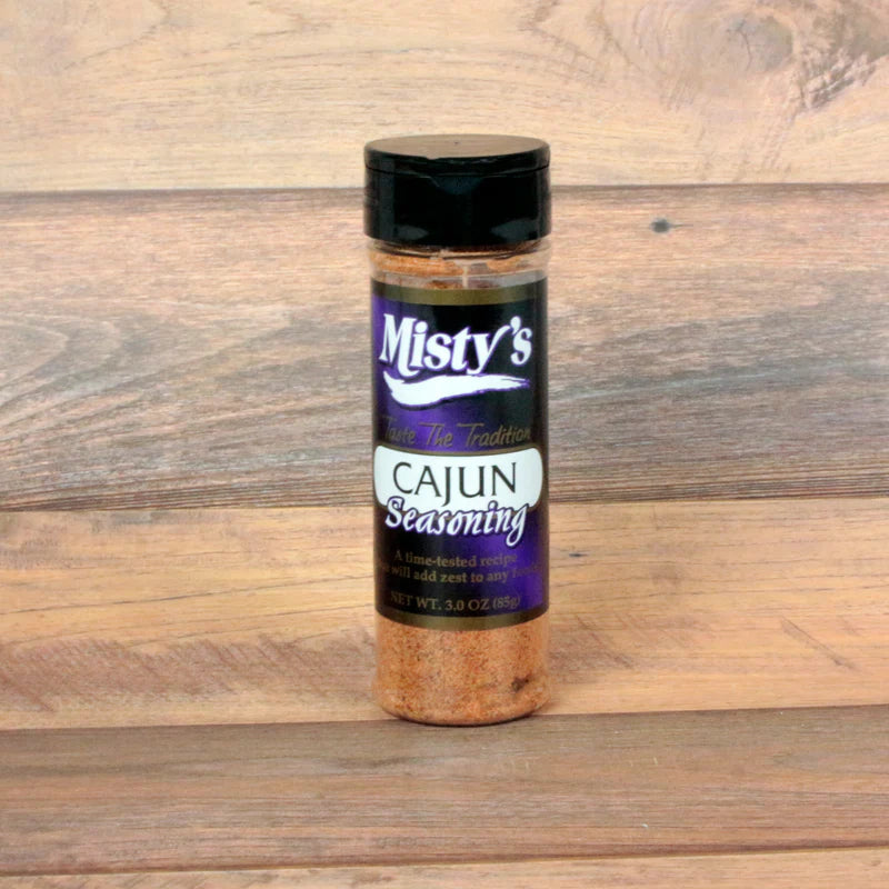 Bottle of Misty's Cajun seasoning on a wooden surface