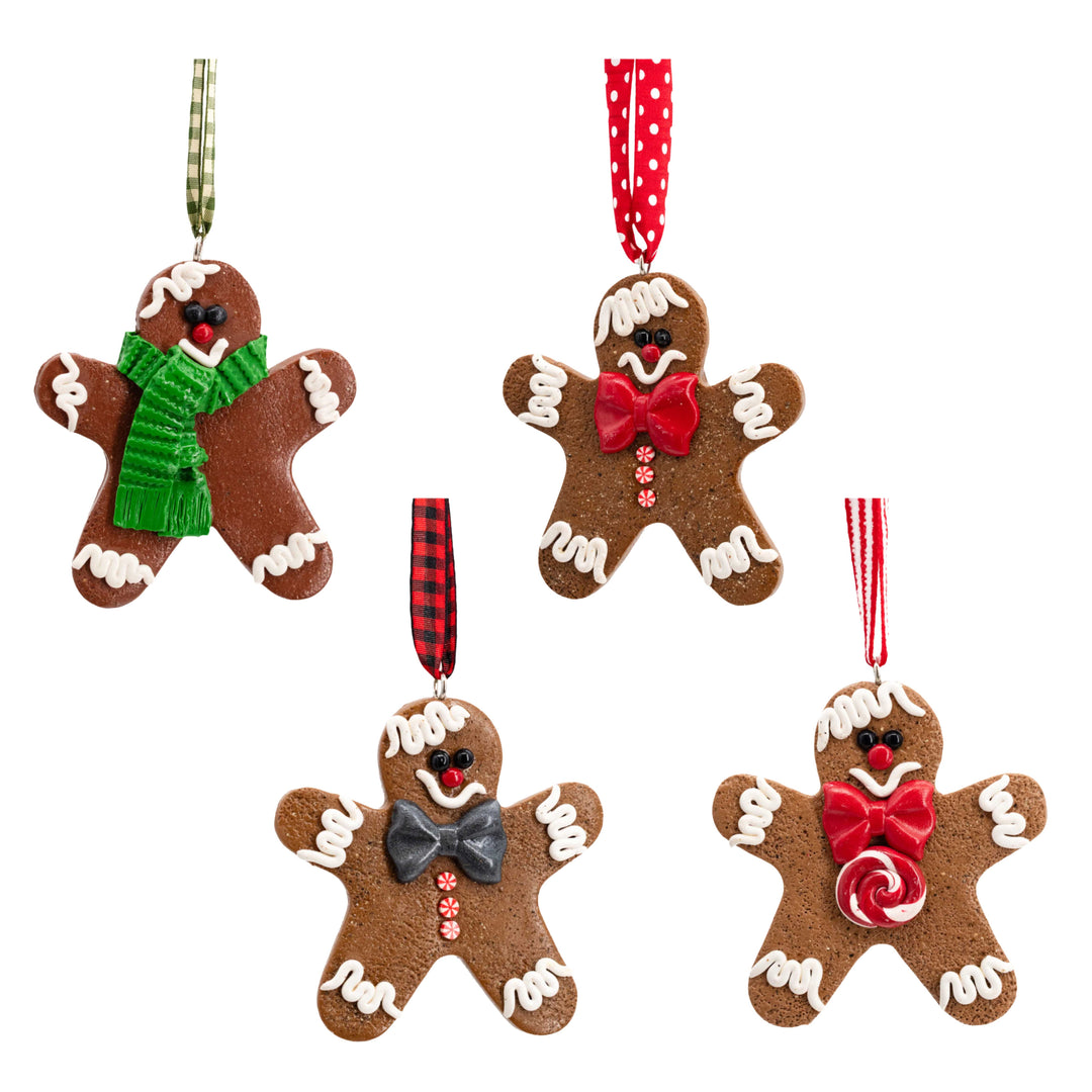 Four gingerbread man ornaments with decorative elements on a white background