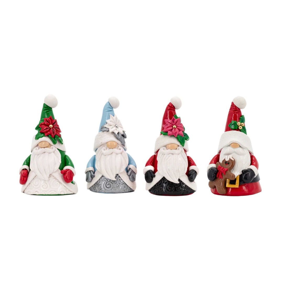Four festive gnome figurines with colorful hats and accessories on a white background