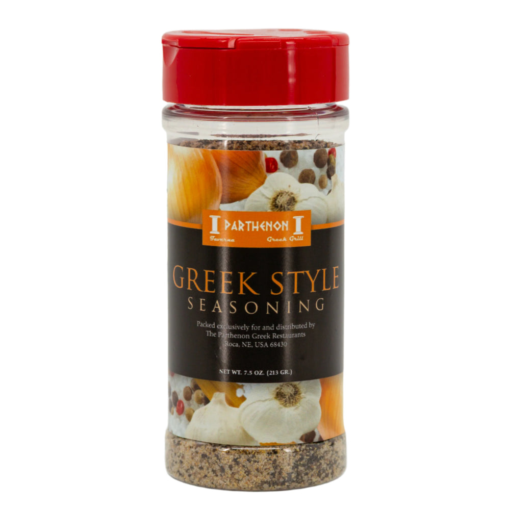 A bottle of Greek Style Seasoning with visible spices through the clear glass and a red cap, labeled for The Parthenon Catering.