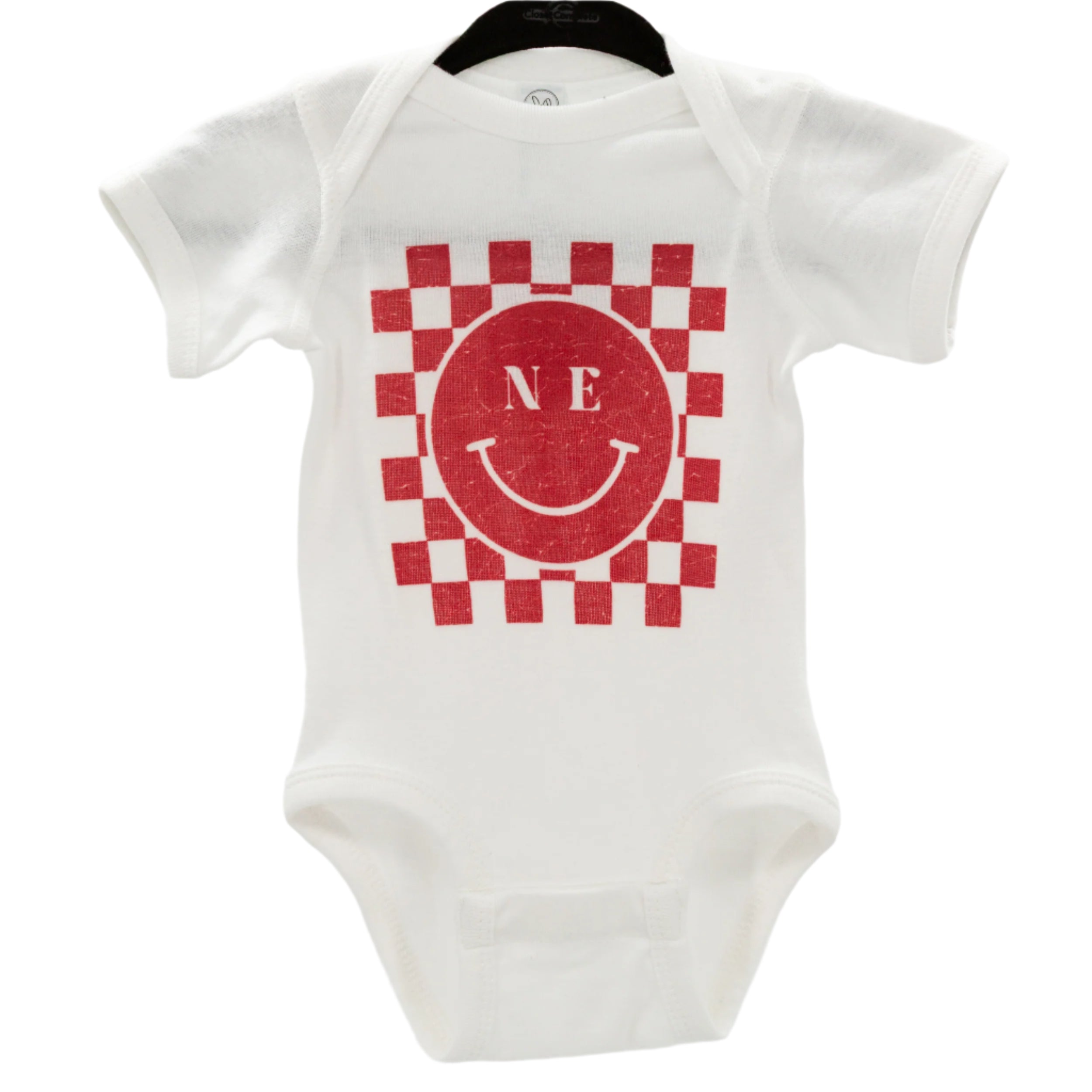 White infant one-piece with a red and gray checkered design and a smiley face in the center, with the letters 'NE' on the top left.