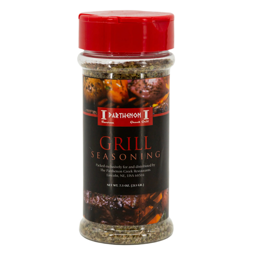A bottle of Greek Style Grill Seasoning by The Parthenon Catering with a red cap and a label showing the product name and weight.