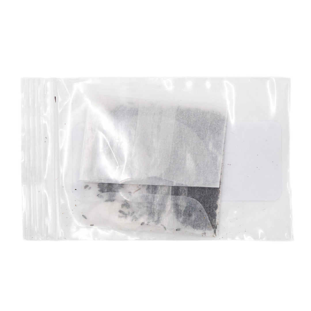 Clear plastic bag with a small amount of white powder on a white background