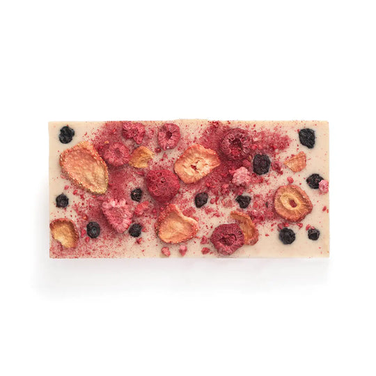 White chocolate bar with mixed berries on a white background