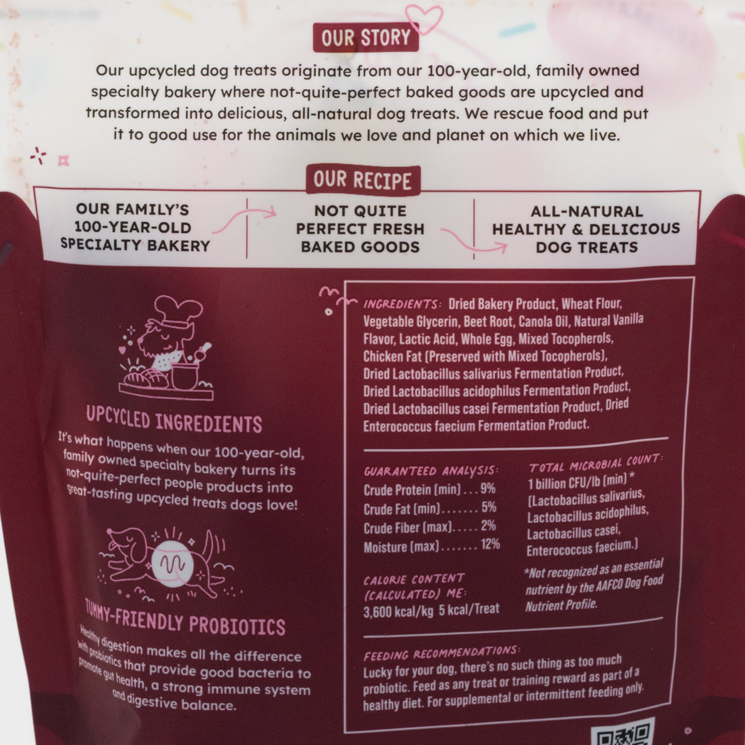 Dog treat packaging with text about upcycled ingredients and family bakery history.