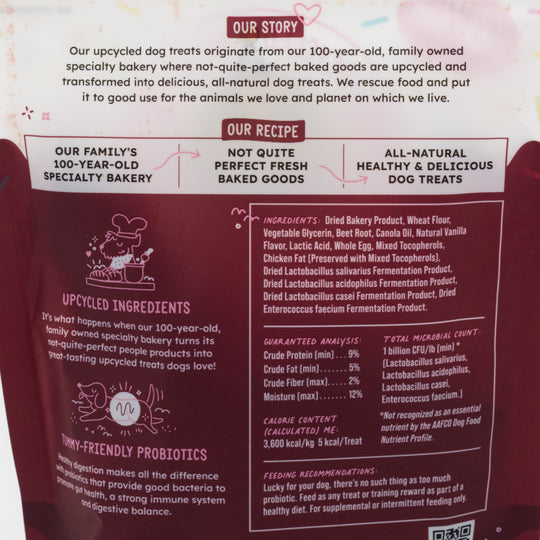 Dog treat packaging with text about upcycled ingredients and family bakery history.