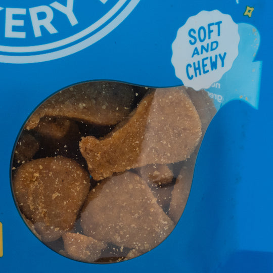 Blue packaging of dog treats with a window showing brown treats and 'Soft and Chewy' text.