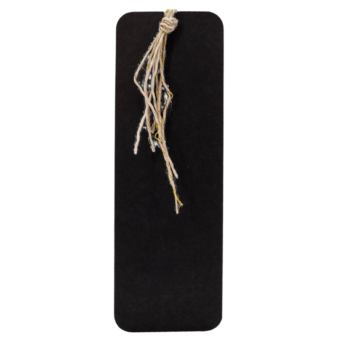 Black rectangular board with a piece of twine tied to it on a white background