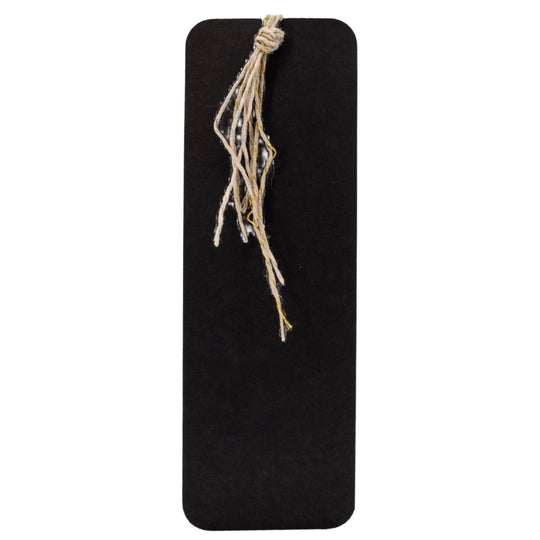 Black rectangular board with a piece of twine tied to it on a white background