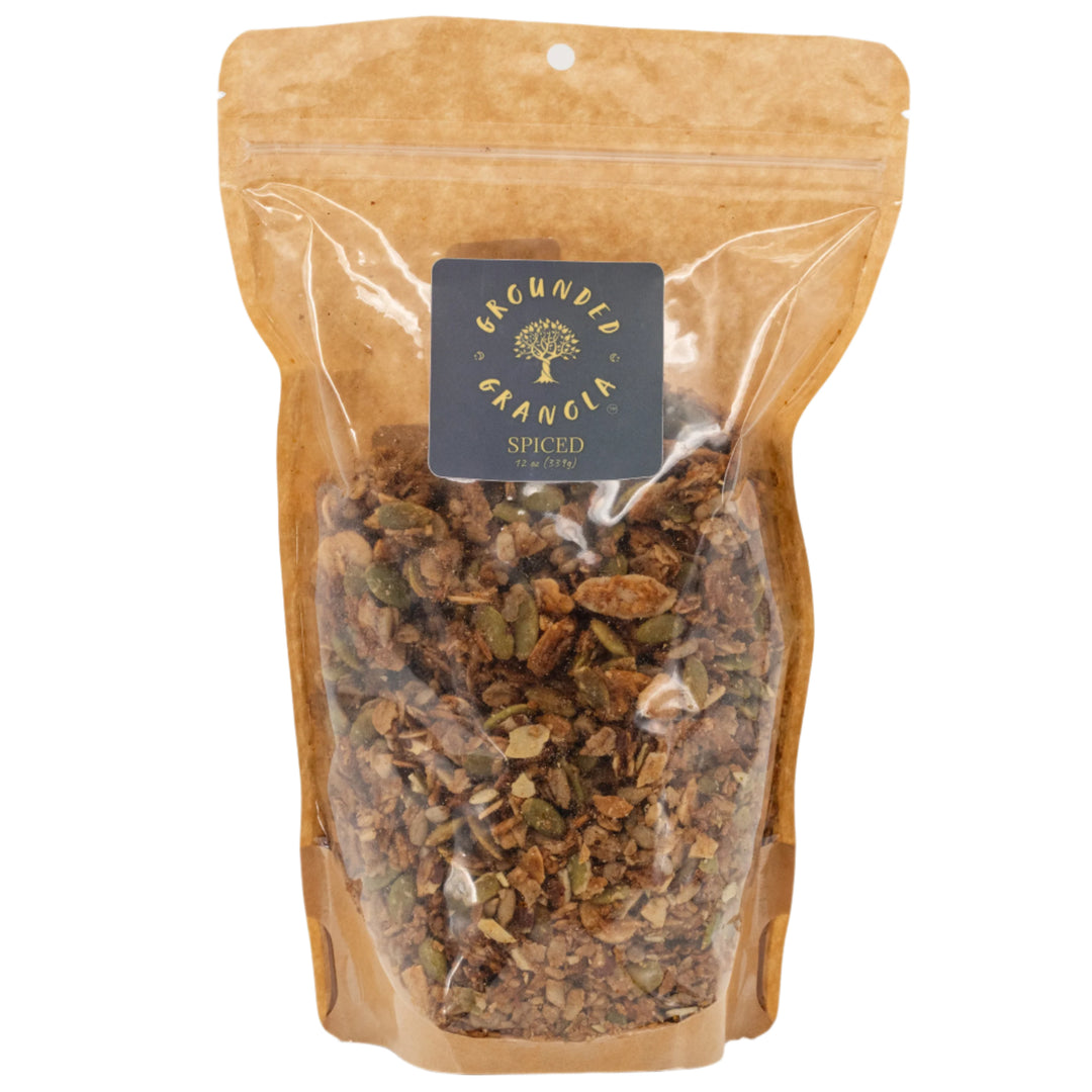 Spiced granola in a clear plastic bag with a branded label on a white background