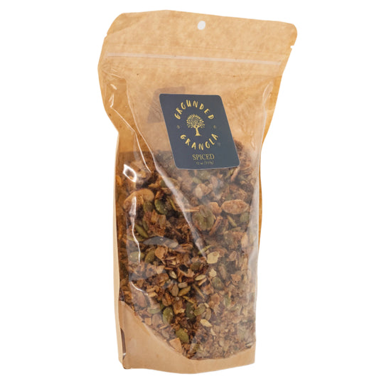 Kraft paper packaging of spiced granola with a visible brand label on a white background