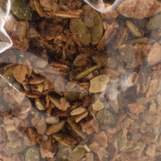 Close-up of a mixture of granola in a clear plastic bag.
