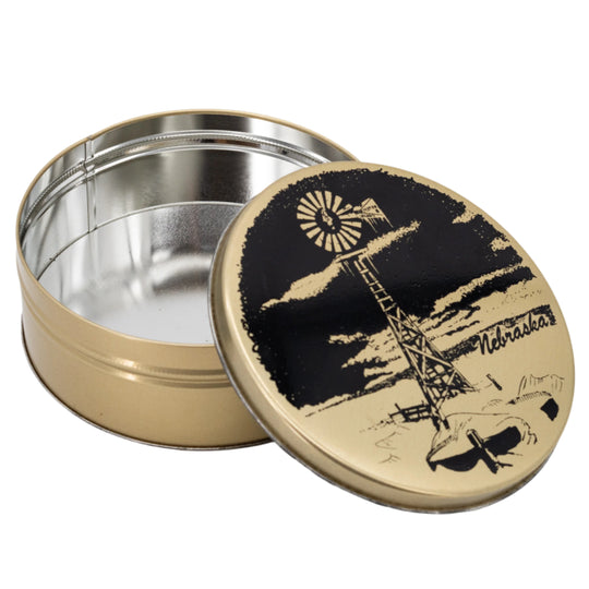 Metal tin with a lid featuring a graphic design of a windmill and crane, on a white background.