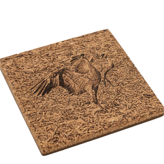 Cork coaster with sandhill cranes engraved.