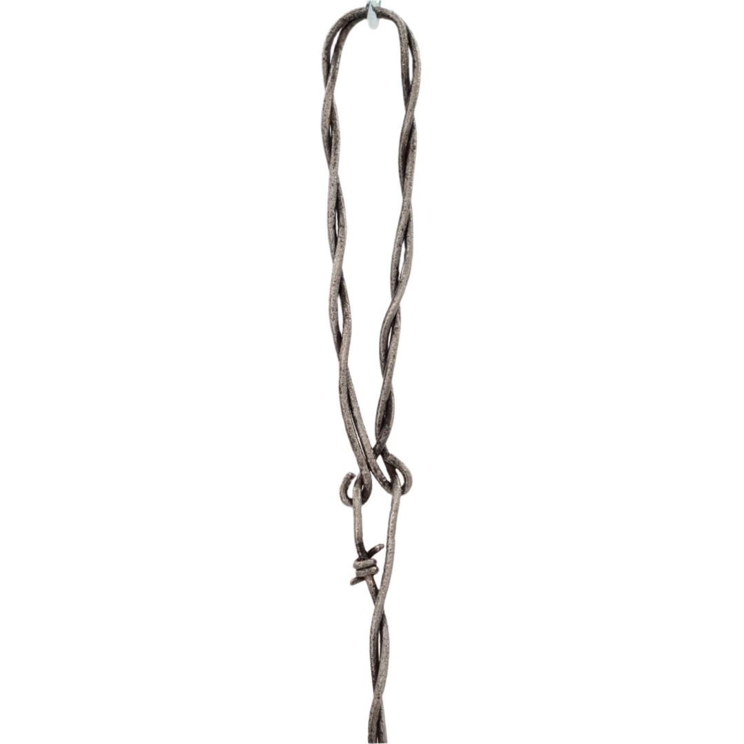 Metallic necklace with a twisted design on a white background