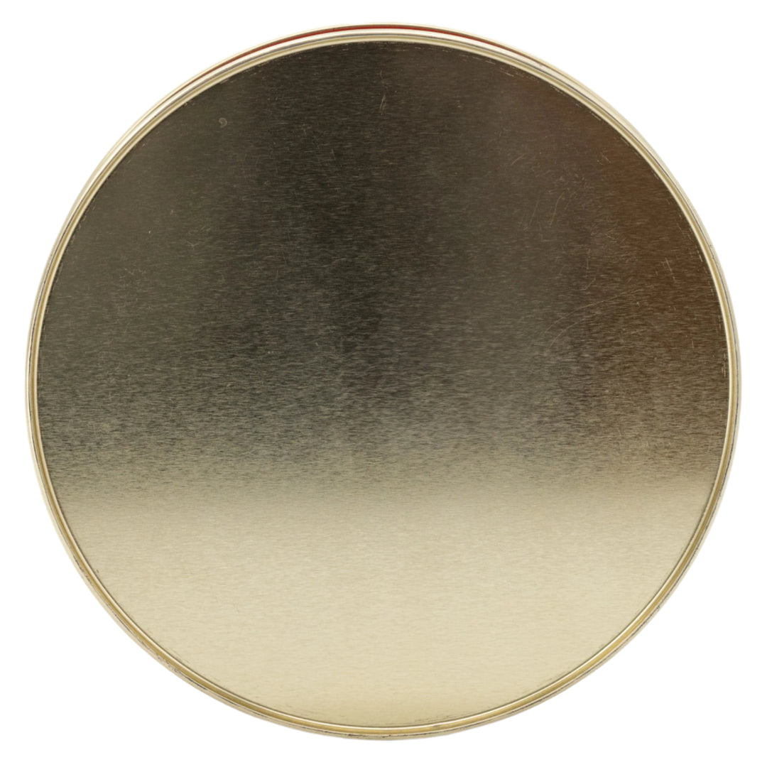Round metallic object with gradient color on a white background