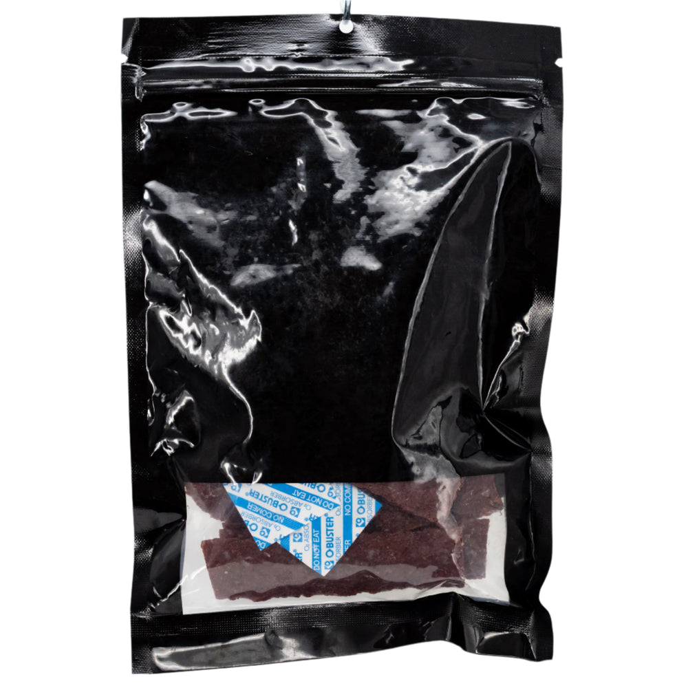 Black plastic bag with a small white label inside on a white background